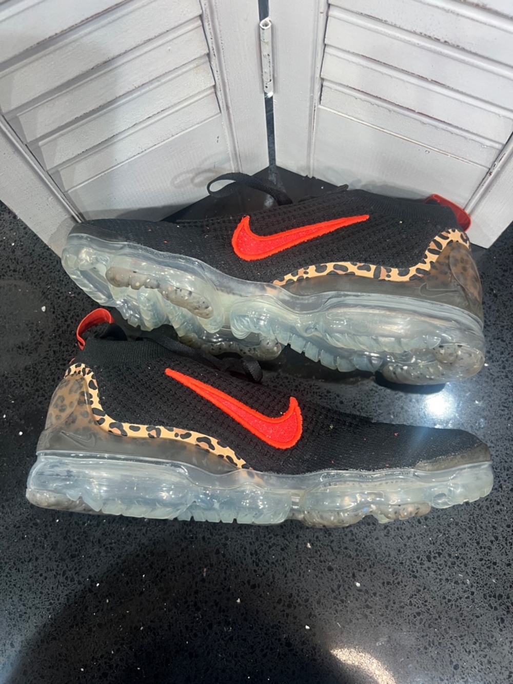 Nike Black Knit Sneakers with Red Swoosh and Leopard Accent